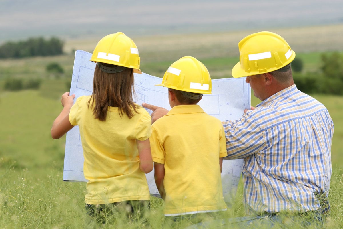 Family-looking-at-blueprints