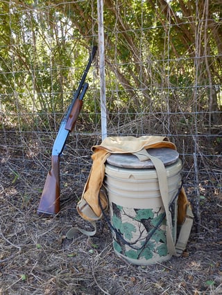 gun-leaning-against-fence.jpg