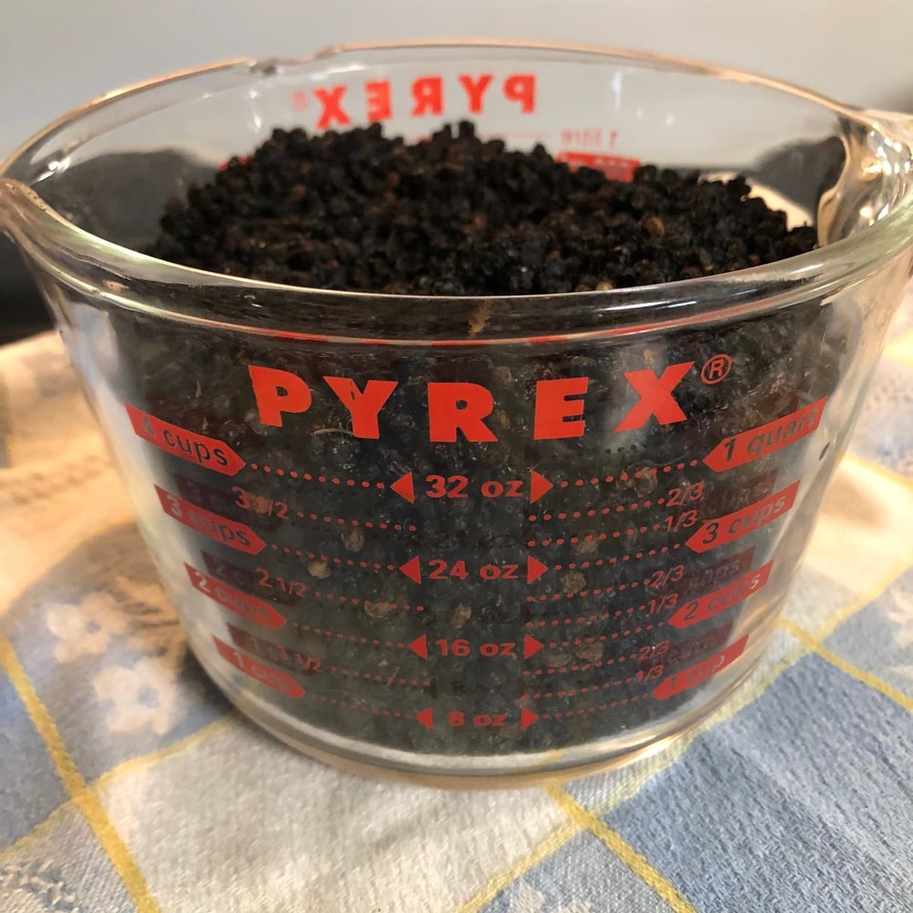 Elderberries in measuring cup