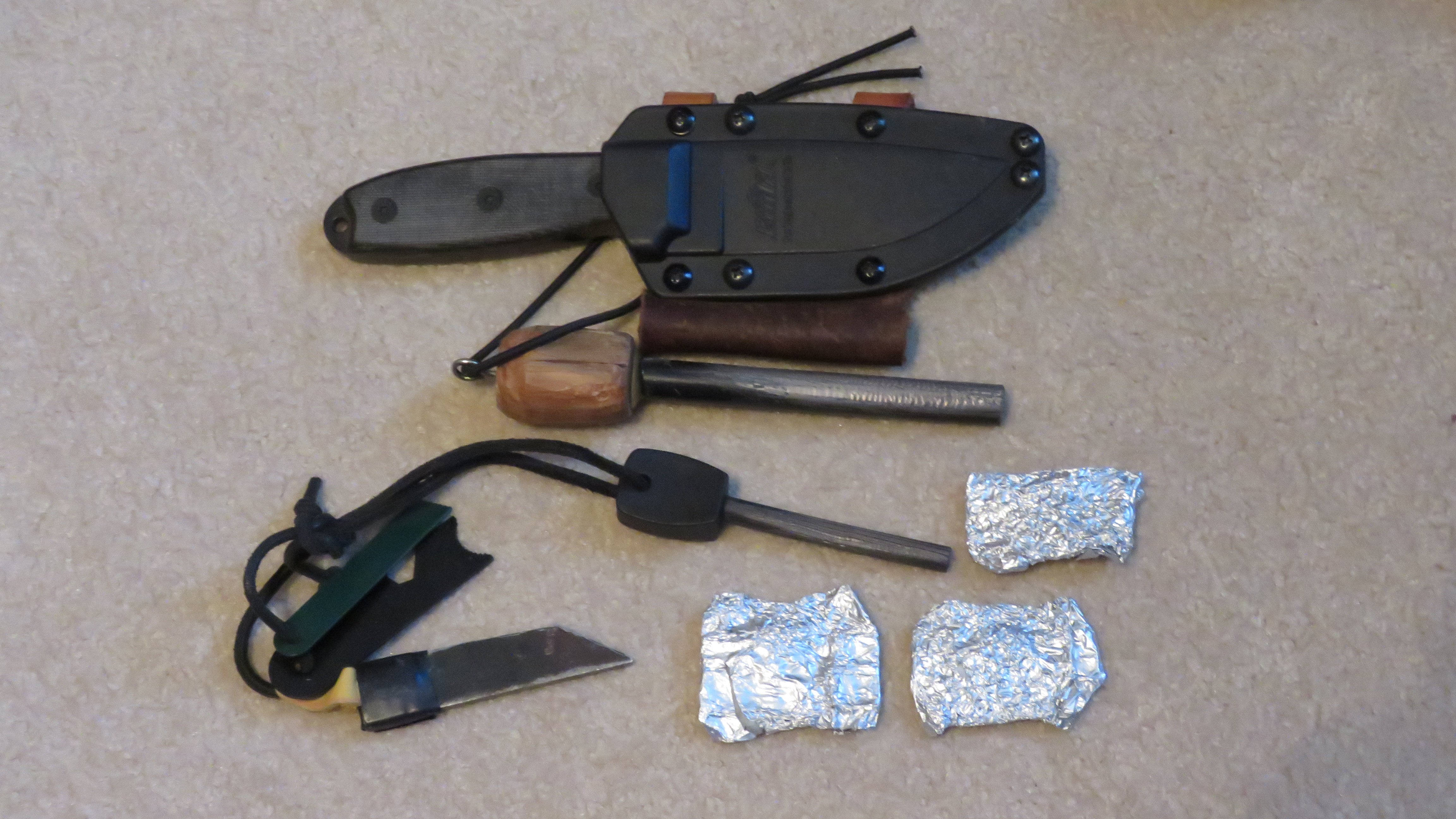 Two sizes ferro rods, knife with modified holster for horizontal carry and slot for ferro rod.