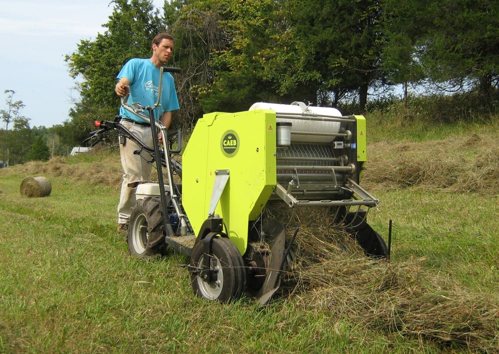 Walk-behind tractor with round haybaler